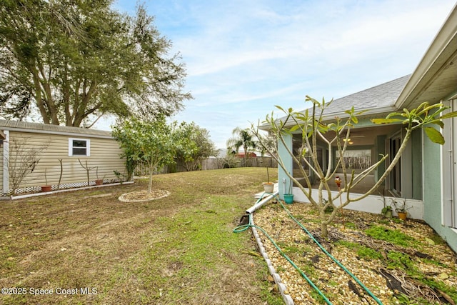 view of yard with an outdoor structure and a sunroom