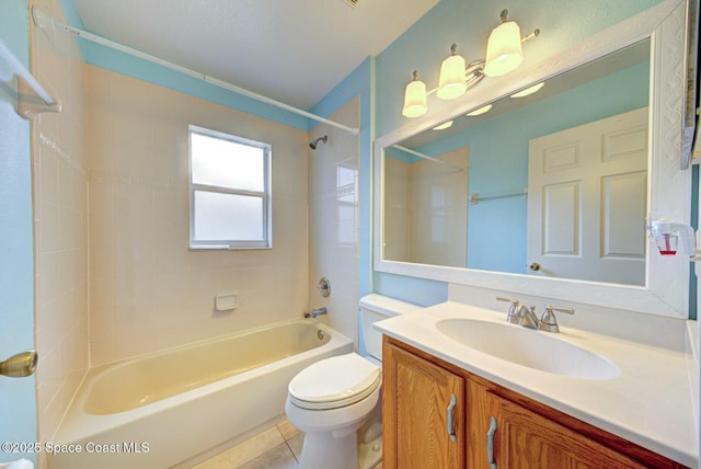 full bathroom featuring vanity, tiled shower / bath combo, tile patterned floors, and toilet