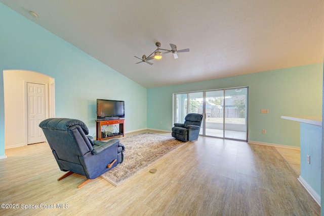 living room featuring high vaulted ceiling, light hardwood / wood-style floors, and ceiling fan