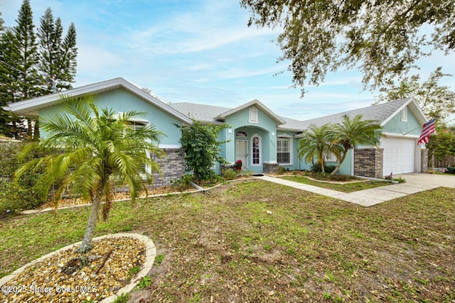 single story home featuring a garage and a front lawn