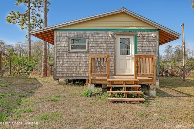 back of house with an outbuilding