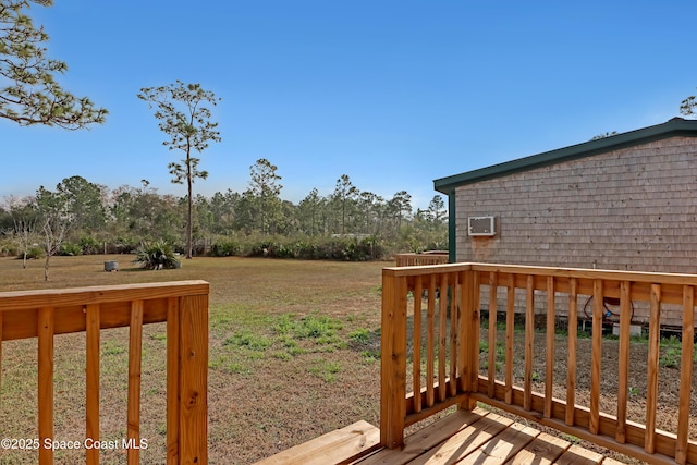 wooden deck featuring a lawn