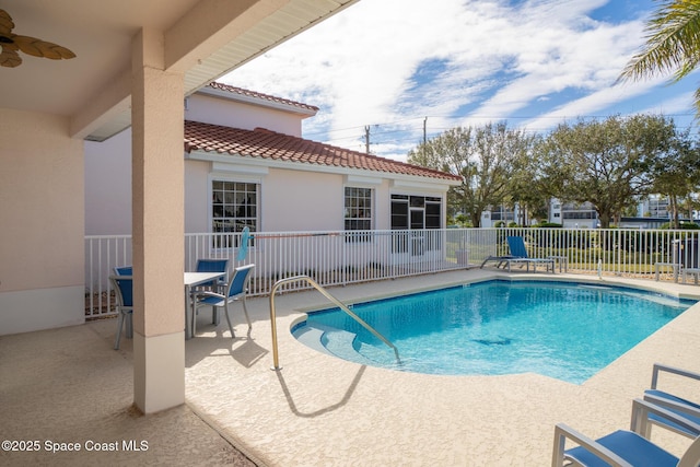 view of swimming pool featuring a patio area and ceiling fan