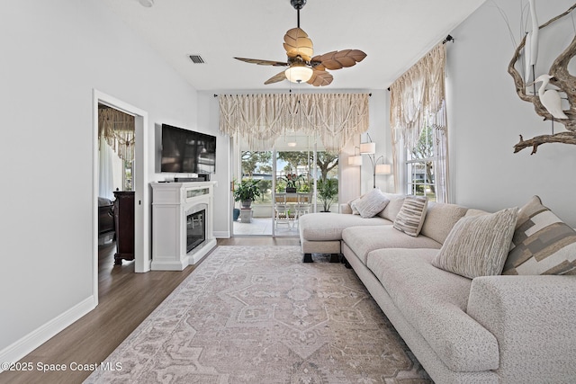 living room featuring dark hardwood / wood-style floors and ceiling fan