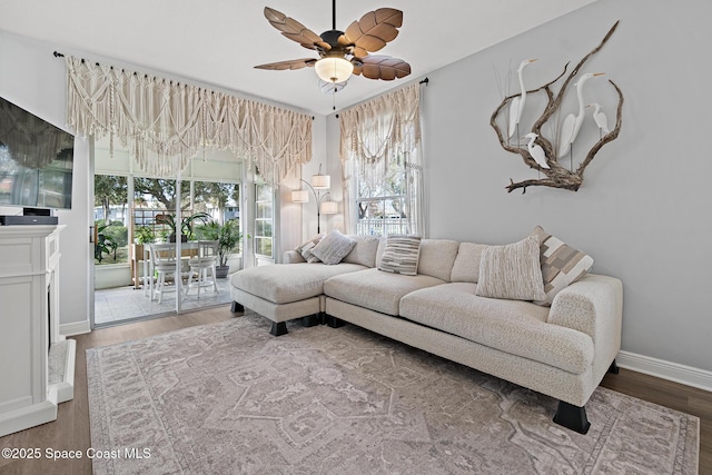 living room with ceiling fan, a healthy amount of sunlight, and wood-type flooring