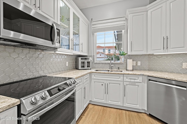 kitchen with white cabinetry, sink, and stainless steel appliances