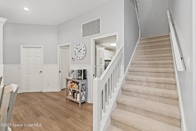 staircase with hardwood / wood-style floors