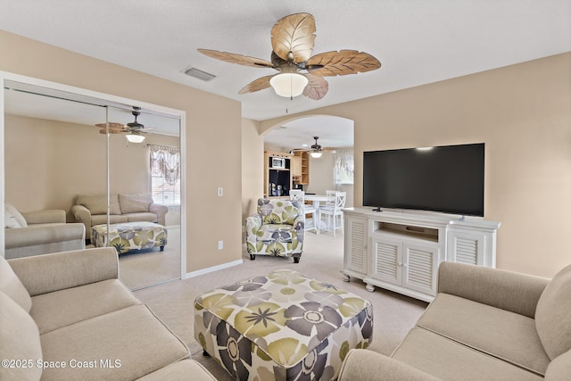 living room featuring carpet floors and ceiling fan