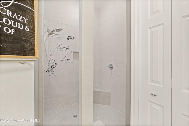 bathroom with tiled shower