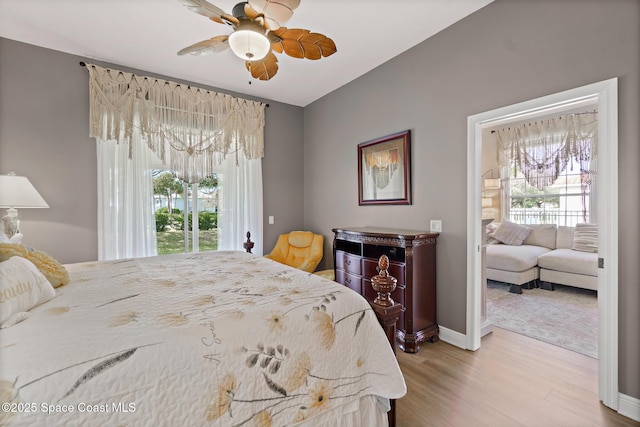 bedroom with multiple windows, light hardwood / wood-style floors, and ceiling fan