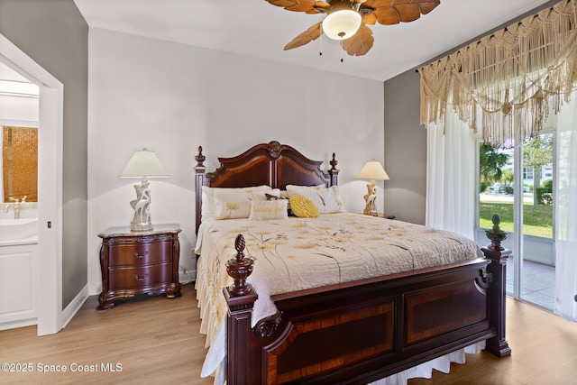 bedroom featuring ceiling fan, access to exterior, sink, and light hardwood / wood-style flooring