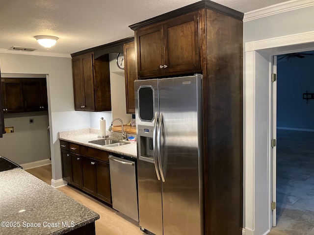 kitchen featuring sink, crown molding, dark brown cabinets, and appliances with stainless steel finishes