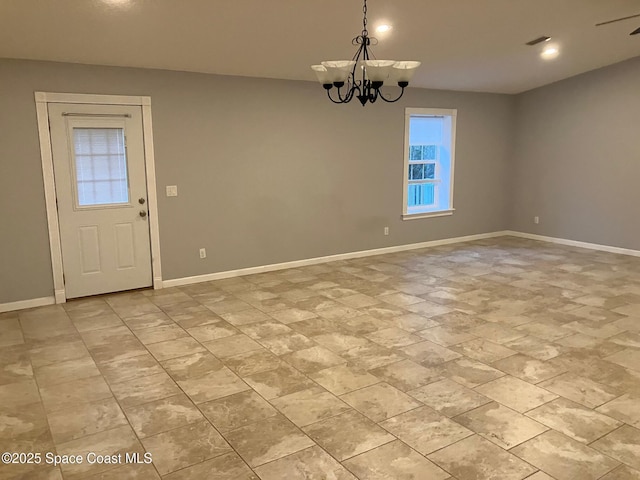 unfurnished dining area with an inviting chandelier