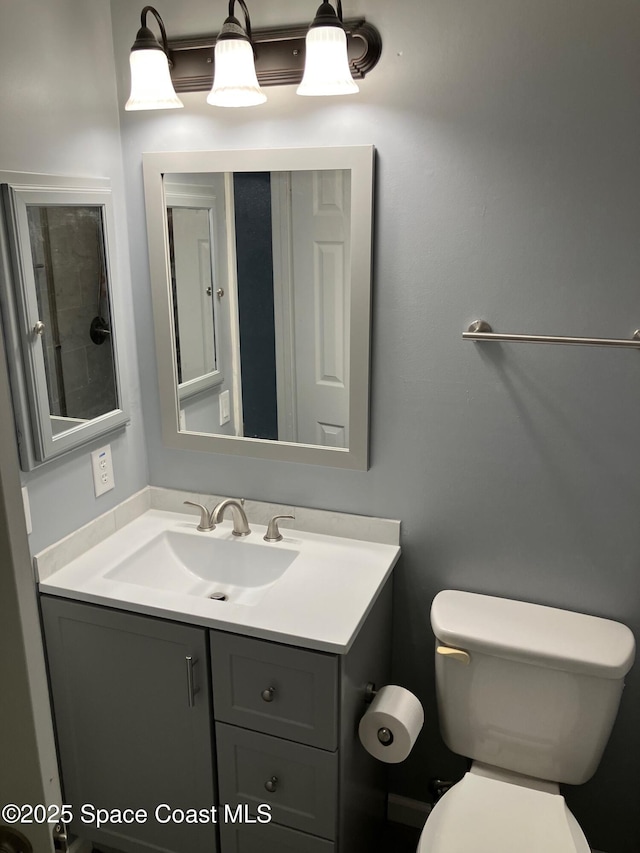 bathroom featuring vanity and toilet