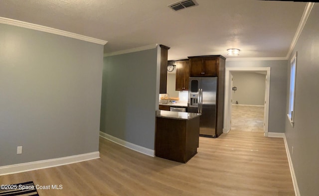 kitchen featuring stainless steel appliances, crown molding, dark brown cabinets, and light wood-type flooring