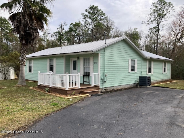 view of front of property with a front yard and cooling unit