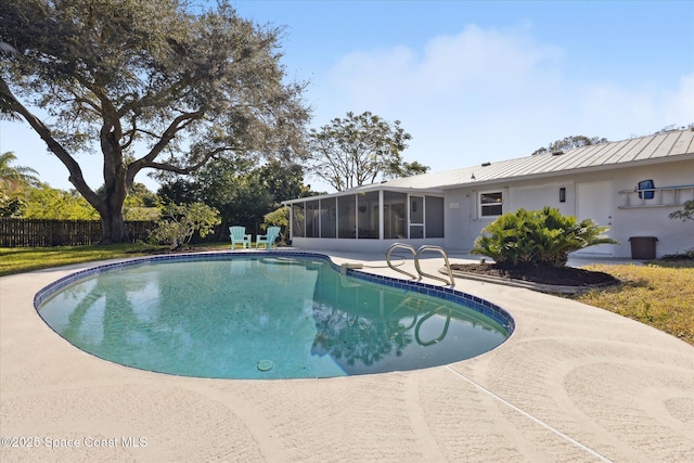 view of pool with a patio area and a sunroom