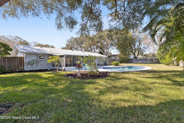 view of yard with a fenced in pool and a sunroom