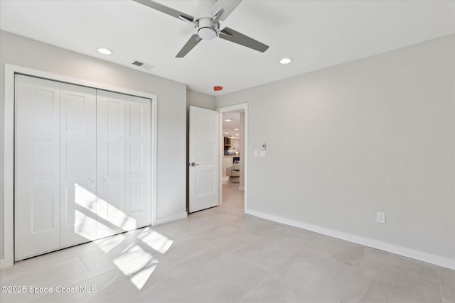 unfurnished bedroom featuring light tile patterned flooring, ceiling fan, and a closet