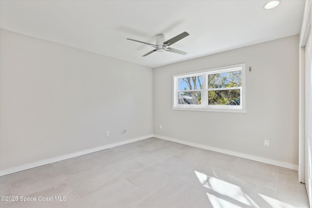 spare room featuring ceiling fan and light tile patterned flooring