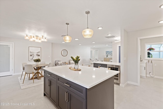 kitchen featuring hanging light fixtures, light tile patterned flooring, and a center island