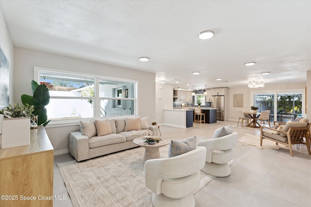 living room with light tile patterned floors and a textured ceiling