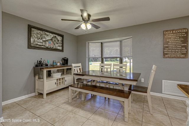 dining space with ceiling fan and light tile patterned floors