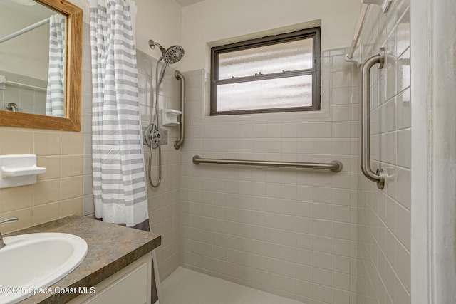 bathroom featuring vanity, tile walls, backsplash, and a shower with shower curtain