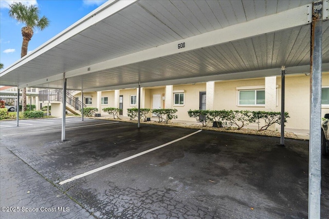 view of vehicle parking with a carport