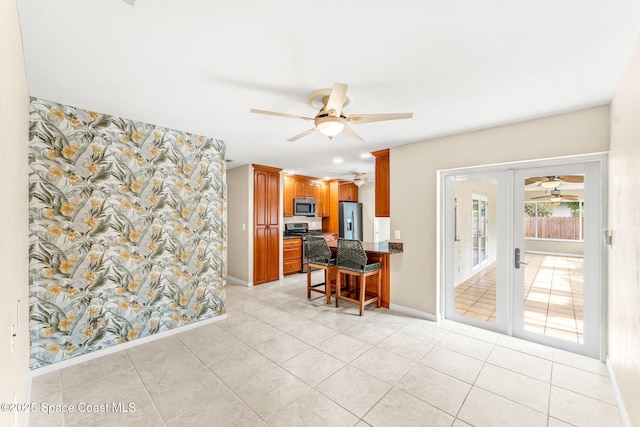 home office with light tile patterned floors, ceiling fan, and french doors