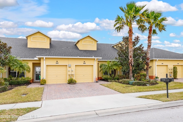 view of front of house with a garage and a front yard