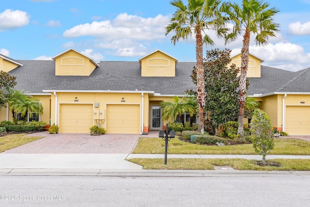 view of front of property with a garage and a front yard