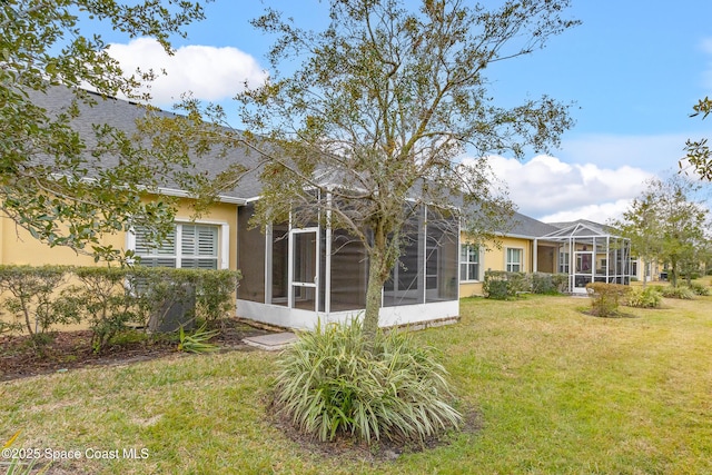 back of house with a lawn