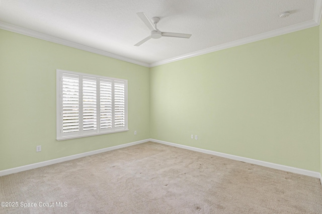 carpeted spare room with crown molding, a textured ceiling, and ceiling fan