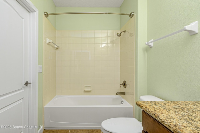 full bathroom with tiled shower / bath, vanity, toilet, and tile patterned floors