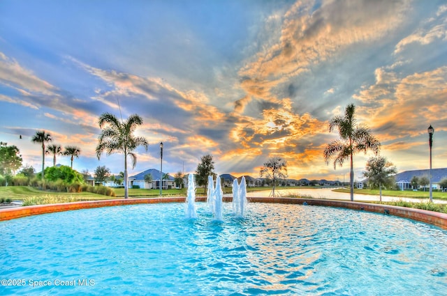 pool at dusk with a water view