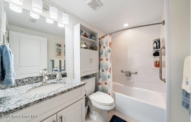 full bathroom featuring shower / bath combo, vanity, a textured ceiling, and toilet