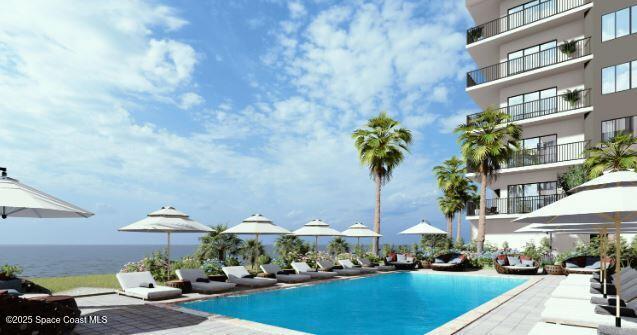 view of pool featuring a water view and a patio area