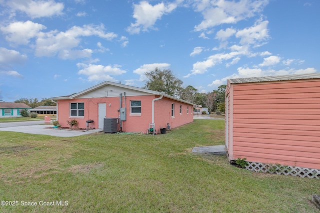 view of home's exterior with a yard and cooling unit