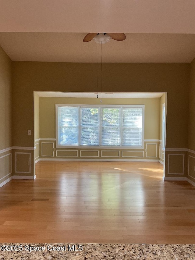 unfurnished room featuring ceiling fan and light wood-type flooring