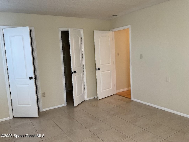 unfurnished bedroom featuring light tile patterned flooring