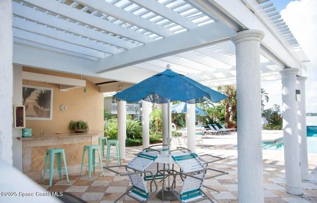 view of patio / terrace with a pergola and an outdoor bar