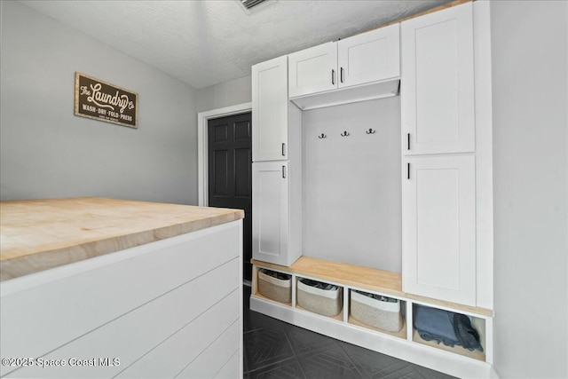 mudroom with a textured ceiling