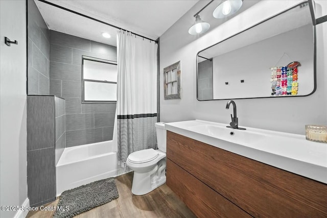 full bathroom with vanity, hardwood / wood-style flooring, shower / bath combination with curtain, and toilet