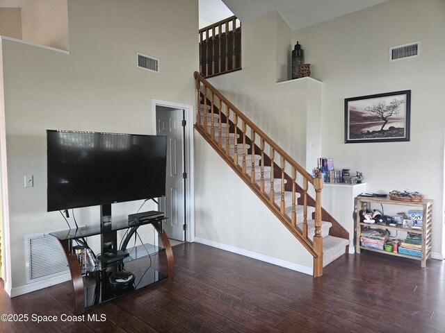 813 Pine Shadows Ave, Rockledge, FL 32955 - staircase featuring baseboards, hardwood / wood-style flooring, a towering ceiling, and visible vents