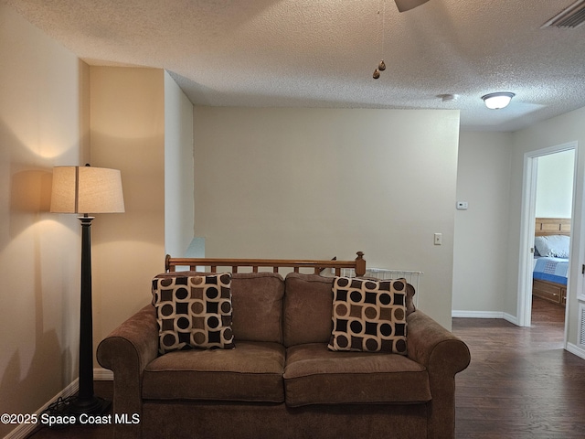 813 Pine Shadows Ave, Rockledge, FL 32955 - living room featuring baseboards, a textured ceiling, visible vents, and wood finished floors