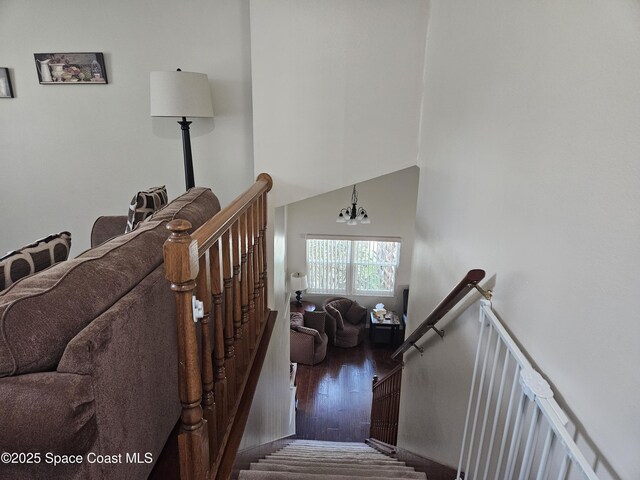 813 Pine Shadows Ave, Rockledge, FL 32955 - stairway with a towering ceiling, hardwood / wood-style floors, and a chandelier