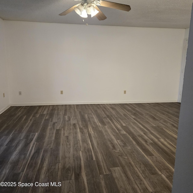 spare room with ceiling fan, dark hardwood / wood-style flooring, and a textured ceiling