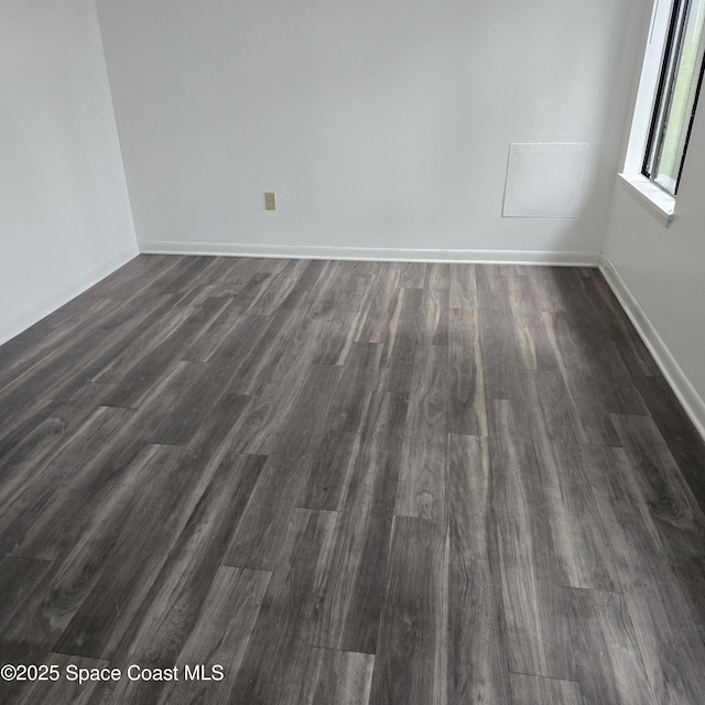 spare room with dark wood-type flooring