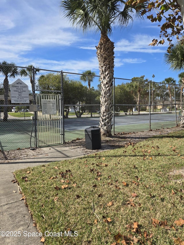 view of sport court with a yard